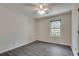 Cozy bedroom with neutral paint, ceiling fan, and large window showing landscaped yard at , Kennesaw, GA 30152