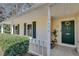 Inviting front porch with decorative wreath, accent plants, and visible house number at , Kennesaw, GA 30152