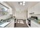 Galley kitchen featuring bright lighting, stainless sink, and gas range stove at , Kennesaw, GA 30152