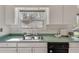 Bright kitchen featuring stainless sink, flower accents, and a window view to the backyard at , Kennesaw, GA 30152