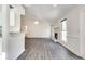 Open-concept living room with vaulted ceiling, brick fireplace, and modern gray wood flooring at , Kennesaw, GA 30152