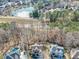Expansive aerial view showcasing homes with a community lake, trees and lush landscape at 1654 Summersweet Ln, Dacula, GA 30019