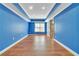 Basement room with blue walls, hardwood floors, and natural light at 1654 Summersweet Ln, Dacula, GA 30019