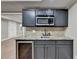 The basement features a wet bar with a wine cooler, stainless steel microwave, and granite countertops at 1654 Summersweet Ln, Dacula, GA 30019