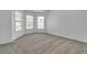 Bedroom with neutral walls and carpet, featuring a bay window at 1654 Summersweet Ln, Dacula, GA 30019