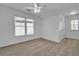 Bedroom with neutral walls and carpet, featuring a ceiling fan, window, and a closet at 1654 Summersweet Ln, Dacula, GA 30019