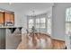 Bright breakfast nook with large windows, a modern chandelier, and an adjacent door at 1654 Summersweet Ln, Dacula, GA 30019