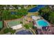 This aerial view features a swimming pool, a playground, and a basketball court within a community park at 1654 Summersweet Ln, Dacula, GA 30019