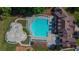 This aerial view shows a beautiful resort-style swimming pool and water park, offering a perfect place to relax at 1654 Summersweet Ln, Dacula, GA 30019