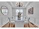 Elegant dining room featuring a modern chandelier and a glass-top table at 1654 Summersweet Ln, Dacula, GA 30019