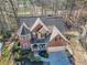 Aerial view of a home with a well-manicured front yard, and a brick facade at 1654 Summersweet Ln, Dacula, GA 30019