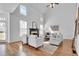 Sun-filled living room featuring hardwood floors, high ceilings, and a cozy fireplace at 1654 Summersweet Ln, Dacula, GA 30019