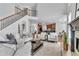 Open-concept living room with a fireplace, staircase, and view to the kitchen and breakfast nook at 1654 Summersweet Ln, Dacula, GA 30019