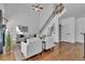 Spacious living room with a soaring staircase, hardwood floors, and a cozy seating area at 1654 Summersweet Ln, Dacula, GA 30019