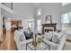 Bright living room with high ceilings, fireplace, and large windows offering plenty of natural light at 1654 Summersweet Ln, Dacula, GA 30019