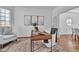 Bright home office featuring neutral decor, hardwood floors, and a comfortable chair by a window at 1654 Summersweet Ln, Dacula, GA 30019