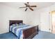 Bedroom with blue carpet, bed and ceiling fan at 3480 Beech Dr, Decatur, GA 30032