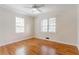 Bright bedroom with hardwood floors, a ceiling fan, and two windows at 430 Lindbergh Ne Dr # A1, Atlanta, GA 30305