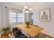 Staged dining area with a wooden table, modern chairs, and minimalist artwork at 430 Lindbergh Ne Dr # A1, Atlanta, GA 30305