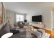 Staged living room with modern gray furniture, area rug, and plenty of natural light at 430 Lindbergh Ne Dr # A1, Atlanta, GA 30305