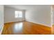 Bright, empty room featuring beautiful hardwood floors, a large window and neutral walls at 430 Lindbergh Ne Dr # A1, Atlanta, GA 30305