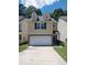 Inviting two-story home features a stone-accented facade, a two-car garage, and dormer windows at 5175 Hanover St, Atlanta, GA 30349