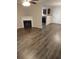 Cozy living room with a fireplace and modern floors, flowing into the kitchen at 5175 Hanover St, Atlanta, GA 30349