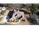 Aerial view showcasing a brick house, landscaped grounds, and circular driveway with ample parking space at 704 Euel Dr, Mcdonough, GA 30252