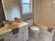 Bright bathroom featuring a tub and shower combo, plus a toilet and a large vanity at 704 Euel Dr, Mcdonough, GA 30252