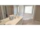 Bathroom features a double sink with white countertops and a separate white tiled tub, offering a relaxing space at 704 Euel Dr, Mcdonough, GA 30252