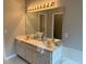 Bright bathroom featuring a double vanity, large mirror, decorative lighting, and bright tile flooring at 704 Euel Dr, Mcdonough, GA 30252