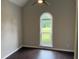 Bright bedroom featuring dark wood floors, large window, ceiling fan, and neutral paint at 704 Euel Dr, Mcdonough, GA 30252