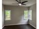 Bright bedroom with hardwood flooring and natural light from three windows at 704 Euel Dr, Mcdonough, GA 30252