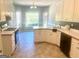 Well-lit kitchen with white cabinets, a window over the sink, and appliances, providing a functional cooking space at 704 Euel Dr, Mcdonough, GA 30252