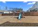 Backyard view featuring a playground set against a backdrop of trees at 7630 Rambling Vale, Cumming, GA 30028