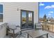 Outdoor balcony with seating area, overlooking the surrounding neighborhood and trees at 7630 Rambling Vale, Cumming, GA 30028