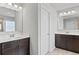 Bright bathroom featuring dual sinks, white countertops and cabinets, and modern lighting at 7630 Rambling Vale, Cumming, GA 30028
