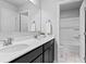 Modern bathroom featuring a double vanity, modern lighting, and clean lines, offering a luxurious and functional space at 7630 Rambling Vale, Cumming, GA 30028
