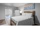 Charming bedroom with wood flooring, a soft bed, and soothing blue artwork at 7630 Rambling Vale, Cumming, GA 30028