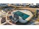 Aerial view of the community pool featuring a pool house, covered pool and playground at 7630 Rambling Vale, Cumming, GA 30028