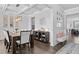 Dining room with modern light fixture, coffered ceilings, hardwood floors, and stylish decor at 7630 Rambling Vale, Cumming, GA 30028