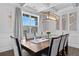 Chic dining room featuring modern lighting and elegant decor, ideal for enjoying meals with Gathering and friends at 7630 Rambling Vale, Cumming, GA 30028