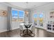 Bright dining area features a glass table, stylish chairs, chandelier, and access to the outdoor deck at 7630 Rambling Vale, Cumming, GA 30028