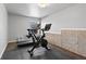 Bright exercise room boasts wood flooring and a stationary bike for a healthy lifestyle at 7630 Rambling Vale, Cumming, GA 30028