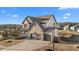 A two-story home with a brick exterior, three-car garage and a well-manicured lawn on a sunny day at 7630 Rambling Vale, Cumming, GA 30028