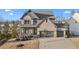 Charming two-story home with brick exterior, large garage, and well-manicured landscaping at 7630 Rambling Vale, Cumming, GA 30028
