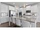 Kitchen with white cabinets, granite countertops, stainless steel appliances and a large center island at 7630 Rambling Vale, Cumming, GA 30028