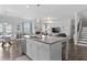 Spacious kitchen with a view into the living room, stairs and dining area at 7630 Rambling Vale, Cumming, GA 30028