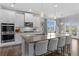 Bright kitchen with a large island, stainless steel appliances, and white cabinets at 7630 Rambling Vale, Cumming, GA 30028