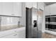 This kitchen has white cabinets, granite countertops, subway tile backsplash, and stainless steel appliances at 7630 Rambling Vale, Cumming, GA 30028